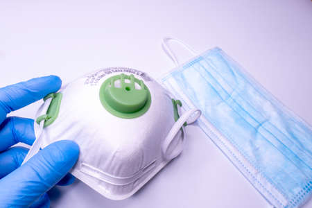 Medical bottle, vials, syringes and face mask on blue background with copy space. Vaccination session and immunity improvement.の写真素材