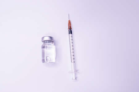 Medicine bottle for injection. Medical glass vials and syringe for vaccination. liquid drug or vaccine for treatment, flu in laboratory, hospital or pharmacy concept isolated on white background.の写真素材