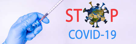 Syringe in a hand of a doctor or nurse and medicine or vaccine vial. Vaccination and immunization concept. Medicine and health care. Vaccine trials and research. Pharmacy. COpy spaceの写真素材