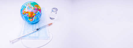 Medical drug vaccine syringe needle hypodermic injection treatment on map world, Medical concept tourism travel care diseases Healthy .Covid 19, Flue shot. selective focus Copy Spaceの写真素材