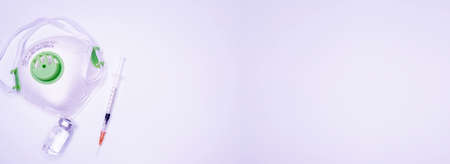 Coronavirus flu and pandemic vaccines, syringe and vial with red liquid on a blue background. medical concept, stethoscope, subcutaneous injection, treatment of the disease. Copy space for text or logo Copy Spaceの写真素材