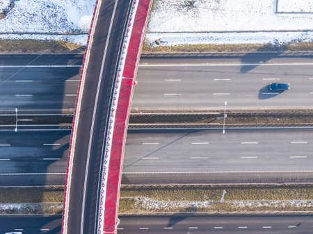 Aerial view of goods warehouse. Logistics center in industrial city zone from above. Aerial view of trucks loading at logistic center. View from drone.の写真素材