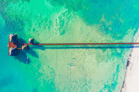 Aerial view of beautiful wooden hotel in Indian ocean at sunset in summer. Zanzibar, Africa. Top...