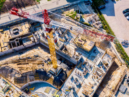 Construction of new multi-storey buildings. Construction crane at dawn on a construction site. View...