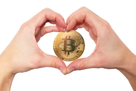 love bitcoin concept. Hands making heart shape gesture with golden crypto coinの写真素材