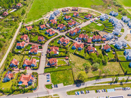 Aerial view of luxury upscale residential neighborhood gated community street real estate with...
