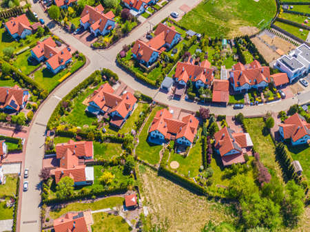 Aerial view of luxury upscale residential neighborhood gated community street real estate with single family homes brick facade colorfulの写真素材