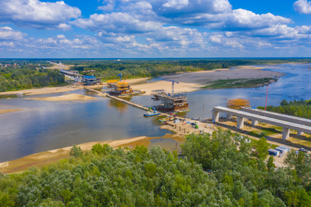Aerial shot passing over a bridge construction project at sunset in Vistula near Warsaw....