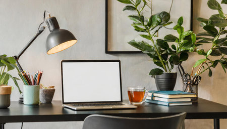 Black chair at table with computer monitor in bright home office interior with poster. Real photoの素材