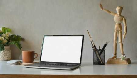 Shelves with illustrations above a wooden desk with computer by a window in a natural, white home office interior for an artistの素材