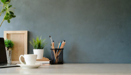 Workspace - office table, empty desk with supplies against the white wall, copy space for text or product showcaseの素材