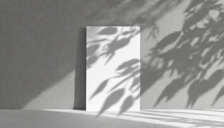 vertical sheets of textured white paper against a soft gray table background. the natural light creates subtle shadows from an exotic plant, enhancing the mockup overlay in a horizontalの素材