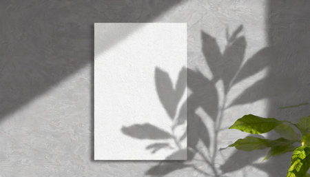 vertical sheets of textured white paper against a soft gray table background. the natural light creates subtle shadows from an exotic plant, enhancing the mockup overlay in a horizontalの素材