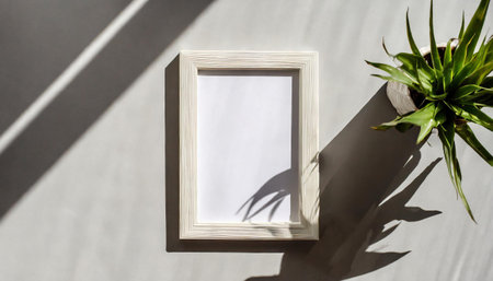 enhancing the mockup overlay in a horizontal, two vertical sheets of textured white paper against a soft gray table background. the natural light creates subtle shadows from an with leaves on tableの素材
