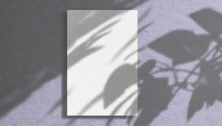 vertical sheets of textured white paper against a soft gray table background. the natural light creates subtle shadows from an exotic plant, enhancing the mockup overlay in a horizontalの素材