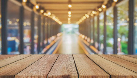 Wooden board empty table in front of blurred background. Perspective brown wood over blur in coffee shop - can be used for display or montage your products.Mock up for display of product.の素材