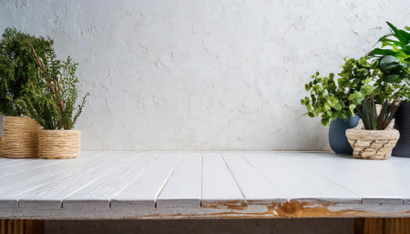 A clean and minimalist empty wooden white table paired with a seamless white wall background, perfect for high-quality product display montages, offering a versatile and aesthetic presentationの素材