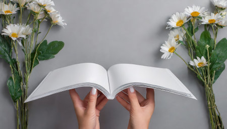Stylish mockup featuring female hands holding a blank magazine on a neutral gray background, ideal for presentations, branding, editorial design, and advertising, offering a versatile, modernの素材