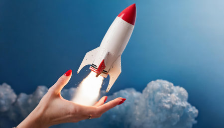 This striking artwork captures the awe of cosmic exploration as a space rocket appears to launch from a woman's hand, set against a serene blue background. A unique blend of and imaginationの素材