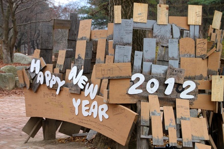 NAMINARA REPUBLIC, KOREA - NOVEMBER 26 : The happy new year 2012 wooden sign is locating for welcome the tourists on November 26, 2011 at Nami island, Naminara Republic, Korea.のeditorial素材