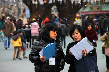 EVERLAND, YONGIN, KOREA - NOVEMBER 26 : The unidentified two women are enjoy travelling and checking data on November 26, 2011 at Everland, Yongin, Korea.のeditorial素材