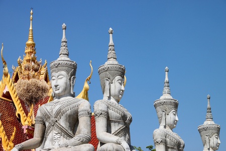 Buddha statues in adorned style on roof of temple