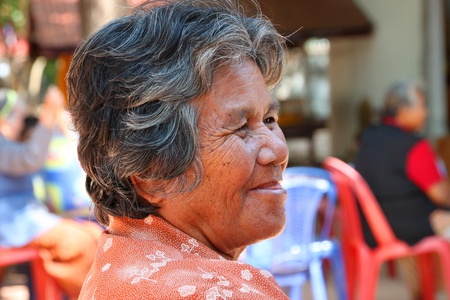 BORABUE, MAHASARAKHAM - NOVEMBER 16 : The unidentified old woman is waiting for haircut service in...