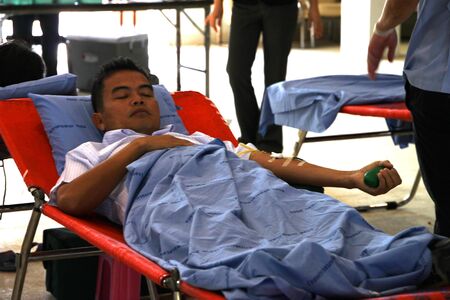 BORABUE, MAHASARAKHAM - JANUARY 6 : The unidentified sacrificer is in blood donation activities on January 6, 2012 at Borabue District Hall, Borabue, Mahasarakham, Thailand.のeditorial素材