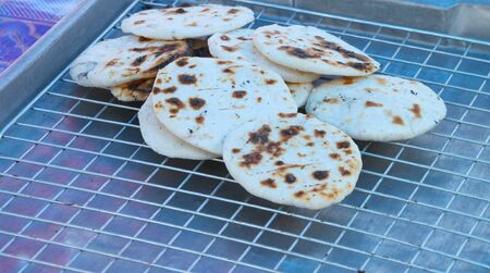 Grilled sweet doughs on stainless steel sieve
