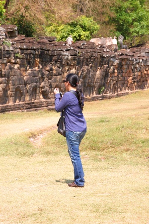 SIEMREAP, KHMER REPUBLIC - FEBRUARY 11 : The unidentified tourist is taking photograph on February 11, 2012 at Terrace of the elephants, Angkor Thom, Siemreap, Khmer Republic.のeditorial素材
