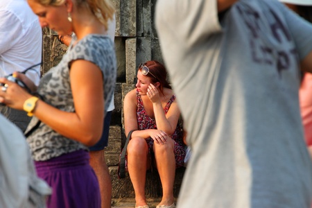 SIEMREAP, KHMER REPUBLIC - FEBRUARY 11 : The unidentified tourists are waiting to see sunset on February 11, 2012 at Phnom Bakheng mountain, Siemreap, Khmer Republic.のeditorial素材