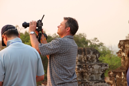 SIEMREAP, KHMER REPUBLIC - FEBRUARY 11 : The unidentified tourist is checking photos on camera on...