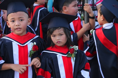 PAYAKKAPHUMPHISAI, MAHASARAKHAM, THAILAND - MARCH 11 : The unidentified children are waiting for school graduation on March 11, 2012 at city hall plaza, Payakkaphumphisai, Mahasarakham, Thailand.のeditorial素材