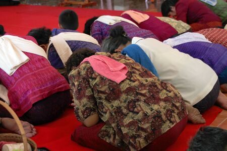 NACHUAK, MAHASARAKHAM - APRIL 10 : Unidentified Buddhists are in religious merit activities on April 10, 2012 at Wat Nong Kung, Nachuak, Mahasarakham, Thailand.のeditorial素材