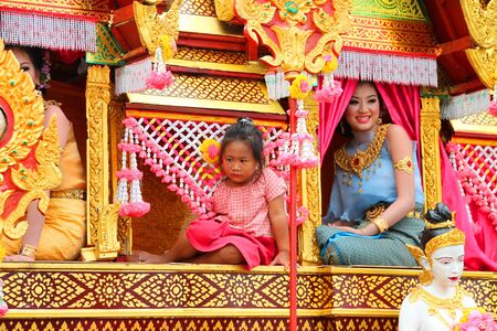 PAYAKKAPHUMPHISAI, MAHASARAKHAM - MAY 19 : Unidentified girls are waiting to join in traditional north-east Thai sky rocket ceremony and festival on May 19, 2012 at footbal playground, Payakkaphumphisai, Mahasarakham, Thailand.のeditorial素材