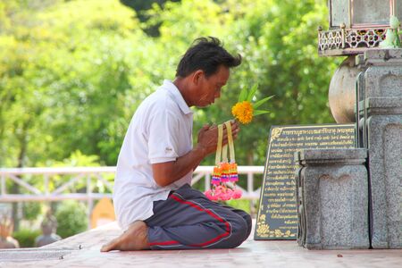 NA DUN, MAHASARAKHAM - JULY 15 : The unidentified Buddhist is making religious merit as usual on July 15, 2012 at Na Dun Pagoda, Mahasarakham, Thailand.のeditorial素材