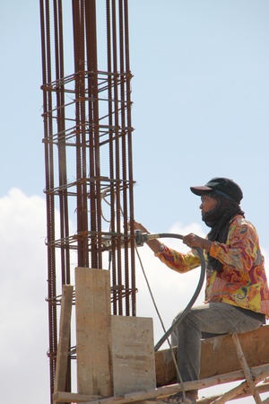MUANG, BURIRAM - JULY 21 : Unidentified man is working in the building site on July 21, 2012 at Taweekit Plaza, Muang, Buriram, Thailand.のeditorial素材