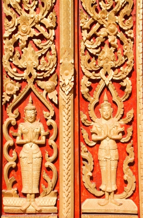 Carving on wooden door in art texture identity of Thai templeのeditorial素材