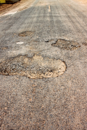 Broken, damaged and cracked road in local motorwayの写真素材