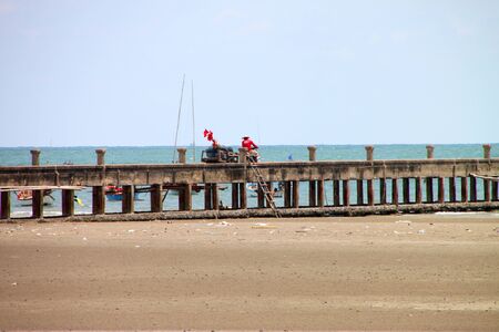 CHANTA BURI, THAILAND - APRIL 21 : Unidentified man is at work on jetty pier on April 21, 2012 at Chao Lhao Beach, Chanta Buri, Thailand.のeditorial素材