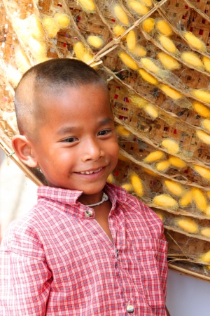 MUANG, BURIRAM - SEPTEMBER 9 : Unidentified boy is standing near threshing basket in silk festival on September 9, 2012 at Taweekit Plaza, Muang, Buriram, Thailand.のeditorial素材