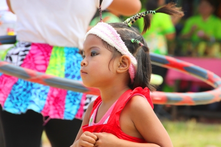 MUANG, MAHASARAKHAM - OCTOBER 5 : Unidentified girl is performing hoola hoop with Thai dance in healthy way of life festival on October 5, 2012 at sport ground, Kerng local administration institute, Muang, Mahasarakham, Thailand.のeditorial素材