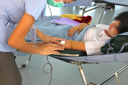 MUANG, MAHASARAKHAM - OCTOBER 26 : Unidentified sacrificers are in blood donation activities on October 26, 2012 at Padung Nari school hall, Muang, Mahasarakham, Thailand.のeditorial素材