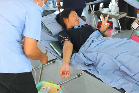 MUANG, MAHASARAKHAM - OCTOBER 26 : Unidentified sacrificers are in blood donation activities on October 26, 2012 at Padung Nari school hall, Muang, Mahasarakham, Thailand.のeditorial素材