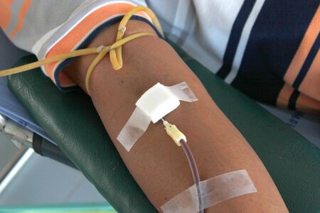 Arm of sacrificers in blood donation and one of activities of Red Cross in Thailandのeditorial素材