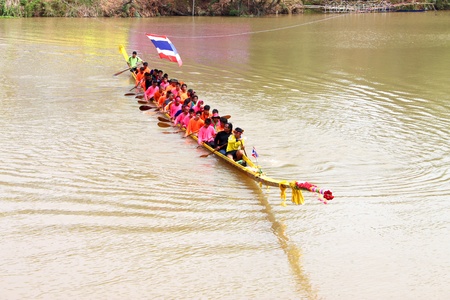 CHEE RIVER, THA TUM VILLAGE, MUANG, MAHASARAKHAM - OCTOBER 29 : The unidentified competitors are performing art of traditional local boat parade, boat contest and racing on October 29, 2012 at Chee river, Ta Tum village, Muang, Mahasarakham, Thailand.のeditorial素材