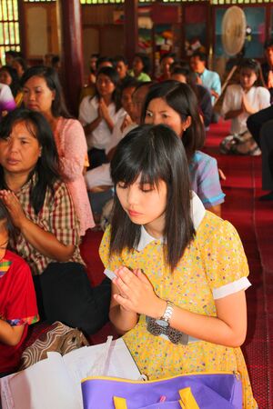 MUANG, MAHASARAKHAM - NOVEMBER 9 : Unidentified Buddhists are making religious ceremony  in which yellow robes and money are presented to the priests at the end of Buddhist Lent on November 9, 2012 at Nong Whai temple, Tha Tum District, Muang, Mahasarakhaのeditorial素材