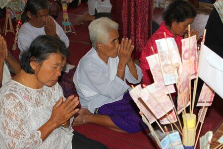 MUANG, MAHASARAKHAM - NOVEMBER 9 : Unidentified Buddhists are making religious ceremony  in which yellow robes and money are presented to the priests at the end of Buddhist Lent on November 9, 2012 at Nong Whai temple, Tha Tum District, Muang, Mahasarakhaのeditorial素材