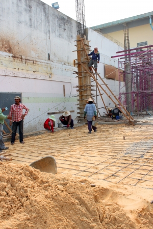 MUANG, BURIRAM - JANUARY 26 : Unidentified workers are working on construction site on January 26, 2013 at Taweekit Plaza Supermarket, Muang, Buriram, Thailand.のeditorial素材