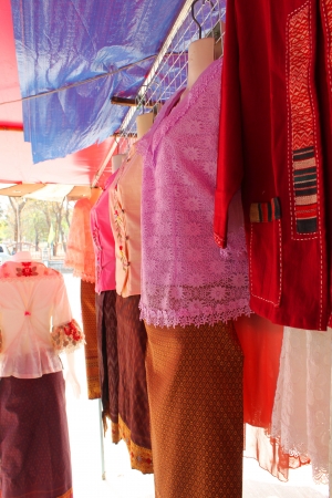 NADUN, MAHASARAKHAM - JANUARY 27 : Colorful clothes are placed for sales on January 27, 2013 at Nadun Pagoda shopping center, Nadun, Mahasarakham, Thailand.のeditorial素材